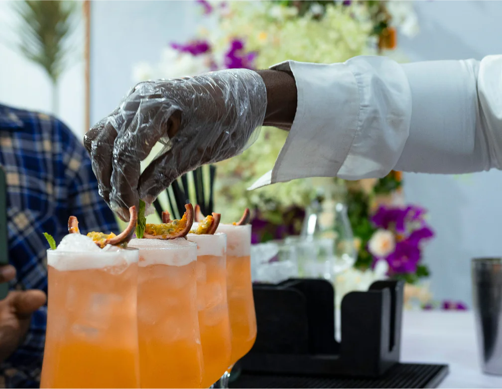 Bartender garnishing signature cocktails at a Lagos wedding reception
