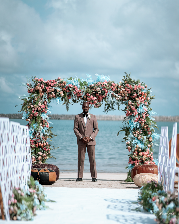 Beachside wedding arch with flowers