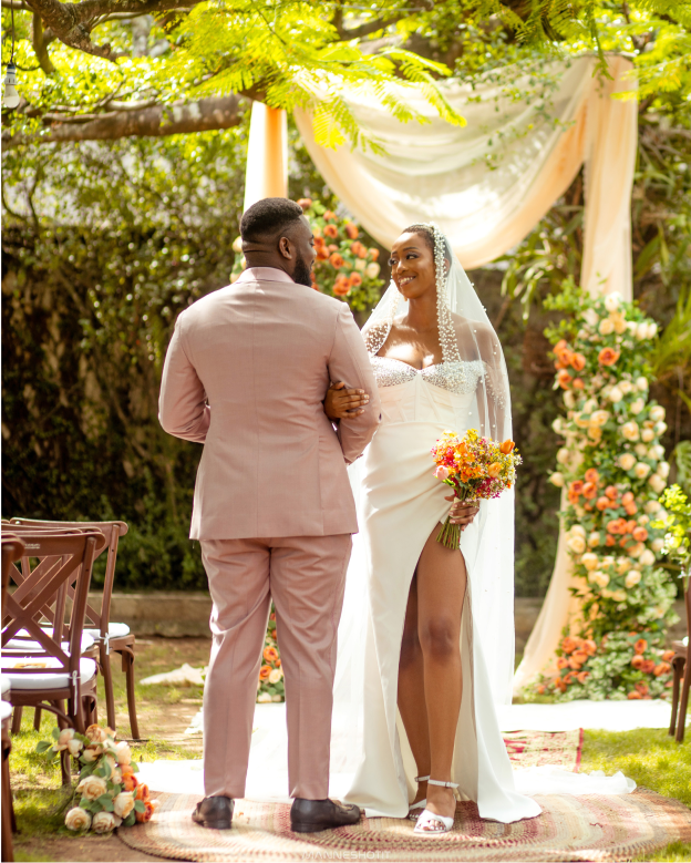 Couple under floral arch